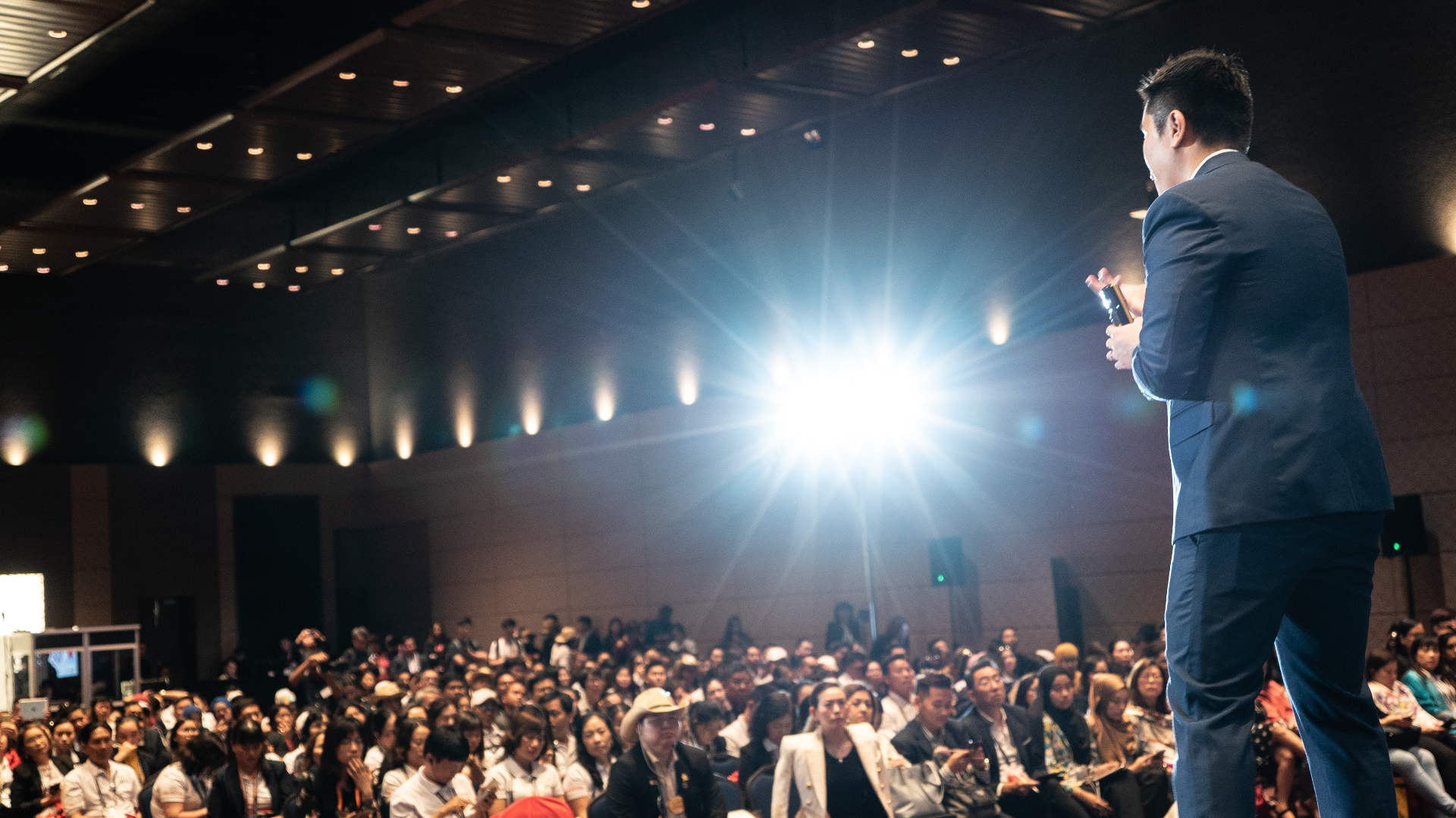 Top of Mind speaker on stage before a large financial services audience